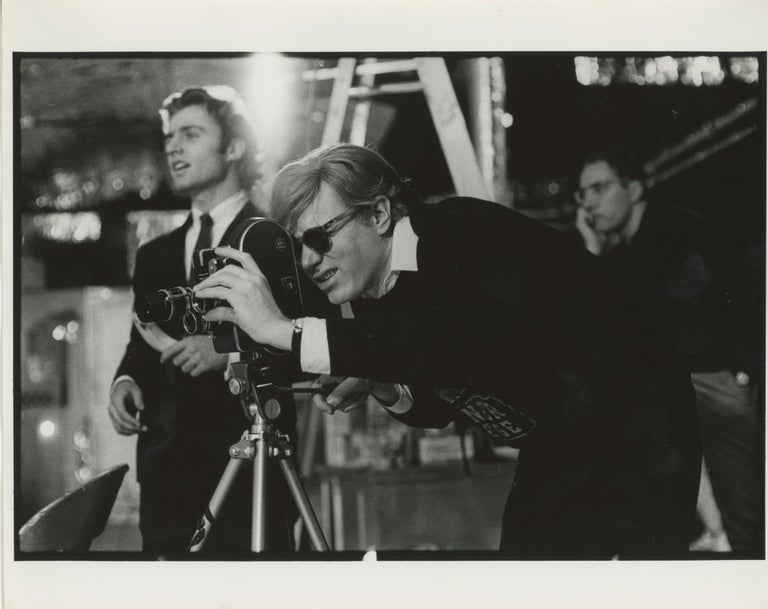 Item #6548 Andy Warhol Operating a Bolex Camera. Billy Name.