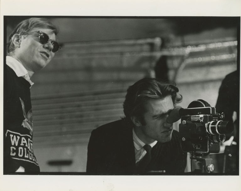 Item #6549 Gerard Malanga and Andy Warhol with Bolex Camera. Billy Name.
