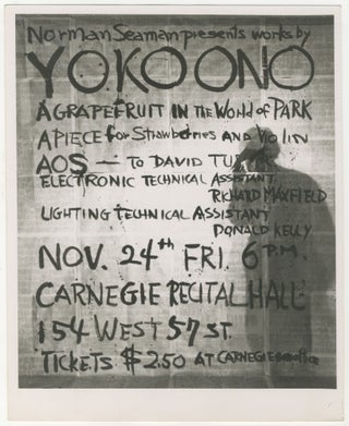Item #6646 Photograph of Yoko Ono with Poster for Works of Yoko Ono at Carnegie Recital Hall....